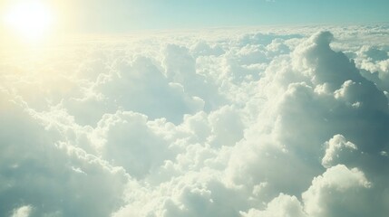 Fototapeta premium Aerial view of fluffy white clouds illuminated by sunlight.