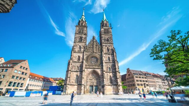 Timelapse of St. Lorenz Church in Nuremberg city center with moving clouds and blue sky, historic Gothic architecture in Germany