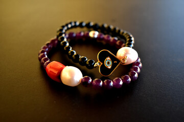 A set of beaded bracelets ona dark surface
