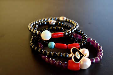 Collection of beaded bracelets on a dark surface