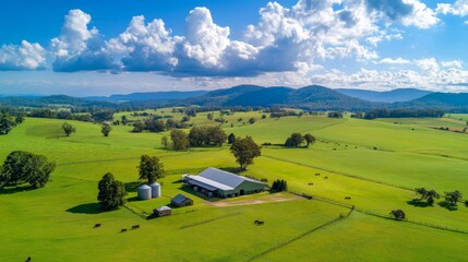 Naklejka premium Aerial View of Farmland with a Barn and Silos