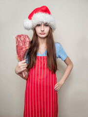 Young girl showing premium tomahawk steak in a plastic wrap. Fine food promotion and advertisement...