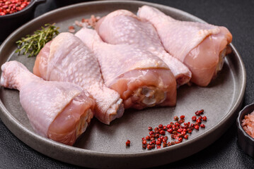 Raw chicken legs with salt, spices and herbs