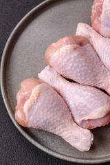 Raw chicken legs with salt, spices and herbs