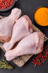 Raw chicken legs with salt, spices and herbs