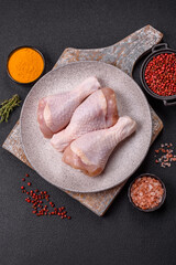 Raw chicken legs with salt, spices and herbs