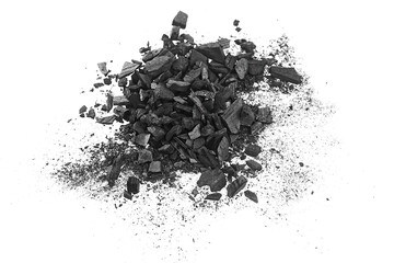 Pile of natural wooden charcoal particles isolated on a white background. Crushed charcoal.