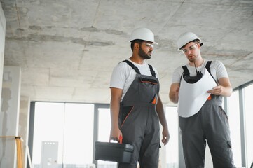 Indian and European construction workers together at a construction site