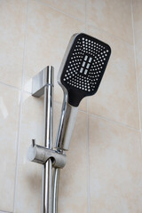 Metal shower rail and shower head. Bathroom arrangement. Interior details. Modern plumbing fixtures for the home.