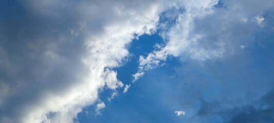 The clouds in sky. In the evening sky there are cumulus and cirrus clouds. They are at different...