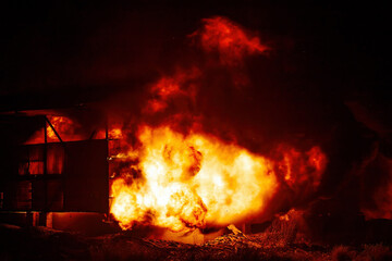 Fototapeta premium Exploding warehouse. Burning industrial building. Big blaze at night