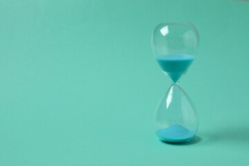 Modern hourglass on color background. Hourglass time concept for business deadline, urgency and...