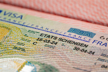 France Schengen visa in passport for visit Europe. closeup