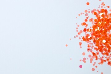 Festive orange confetti on white background
