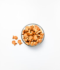Biscuits shaped like cute fish served in bowl isolated on a white background