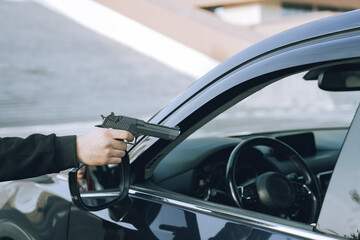 A robber with a gun and a mask attacked a female driver