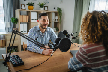 adult man interviewer ask woman guest questions while record podcast