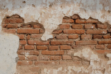 Old damaged brick wall texture background.The shape, pattern and surface texture old red brick wall . The old wall is peeling and grunge. Natural texture background.Graphic design or banner background