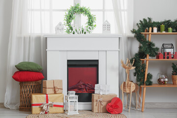 Interior of living room with Christmas mistletoe wreath, fireplace and shelf unit