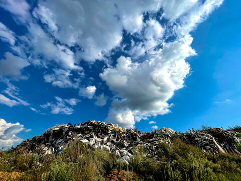 Garbage dump on the sky background. Nature's struggle with garbage