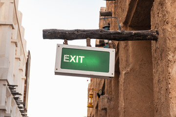 Sign indicating exit direction at street entrance