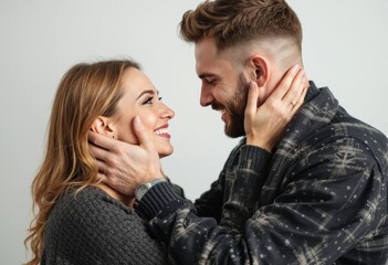 genuine joy radiates between partners as they share an intimate moment their hands tenderly cupping each others faces while natural laughter and happiness fills their expressions