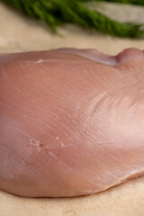 Fototapeta premium a piece of fresh chicken meat in close-up lies on paper