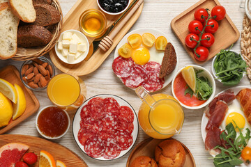 Different tasty food served for brunch on white wooden table, flat lay