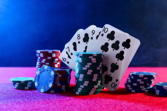 Poker chips and playing cards on pink table - Powered by Adobe