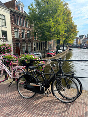 Fototapeta premium Modern bicycles parked near water canal in city