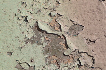A beautifully textured surface featuring peeling paint and visible cracks for added character