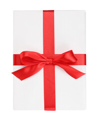 One book with red ribbon as gift isolated on white, top view