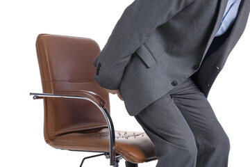 Businessman sitting down on chair with pins against white background. Hemorrhoids concept