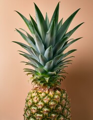 Fototapeta premium A vibrant pineapple against a warm peach backdrop.