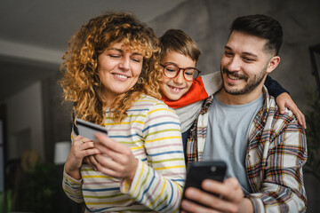 Family enjoy online shopping together with credit card at home