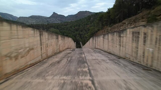 Aerial drone flight through Conde de Guadalhorce-Gaitanejo reservoir water slide system in Andalusia Spain