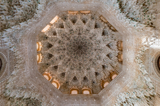 Granada, Spain 2022 : Alhambra palace, Sala de las Dos hermanas Two sisters Hall. Upview of octogonal flower Shaped Ceiling dome of mocarabes Stucco-carved muqarnas and plasterwork covered wall.