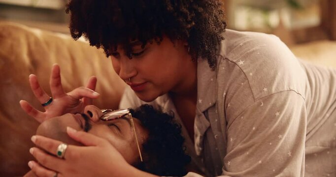 Home, couple and kiss on forehead for bonding, love and connection together with affection in lounge. Happy people, man and woman with embrace for commitment, trust and romantic relationship in house