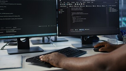 Programmer in server farm workspace protecting data threatened by hacking attacks on computers. IT...
