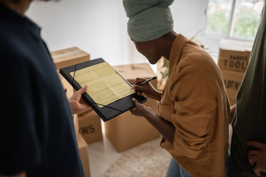 Wife signing house moving services contract
