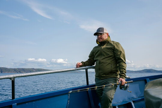 A Man Fishes From a Boat in the Barents Sea, Arctic