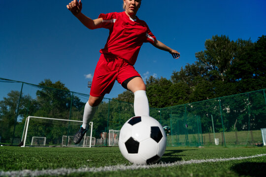 Female soccer player training with the ball