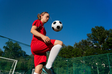 Female soccer player training with the ball