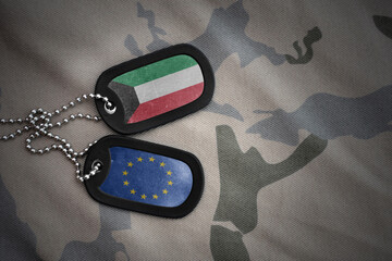 army blank, dog tag with national flag of kuwait and european union on the khaki texture background. military concept.