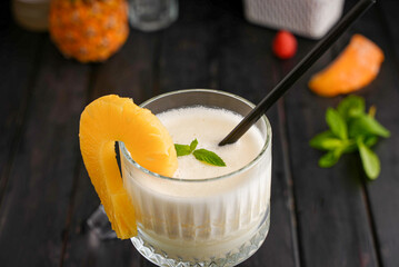 Homemade frozen Pina Colada cocktail with rum, coconut milk and pineapple garnish And fruit over...
