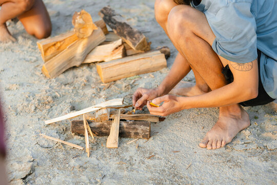 A man lights a fire