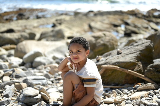 Little boy playing near the ocean.