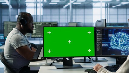 IT support workers in AI data center coding on green screen computers, upgrading equipment....