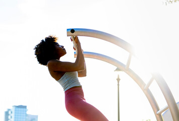 Young healthy black athlete doing pull up strength training 