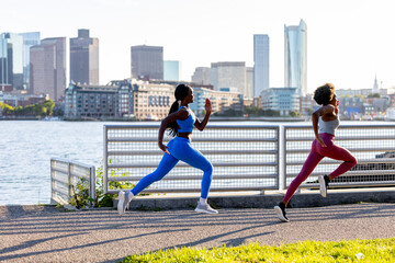 Two healthy determination black athletes running in Boston